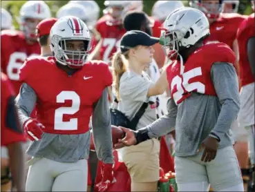  ?? KYLE ROBERTSON — THE COLUMBUS DISPATCH VIA THE ASSOCIATED PRESS ?? Ohio State running backs J.K. Dobbins, left, and Mike Weber warm up during practice at Woody Hayes Athletic Center in Columbus on Aug. 7.