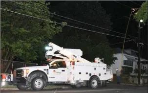  ?? The Sentinel-Record/Grace Brown ?? POWER RESTORED: An Entergy Arkansas Inc. employee works to restore power at the intersecti­on of Hobson Avenue and Pearl Street at around 9:20 p.m. Wednesday. Power was restored to the area in about 30 minutes.