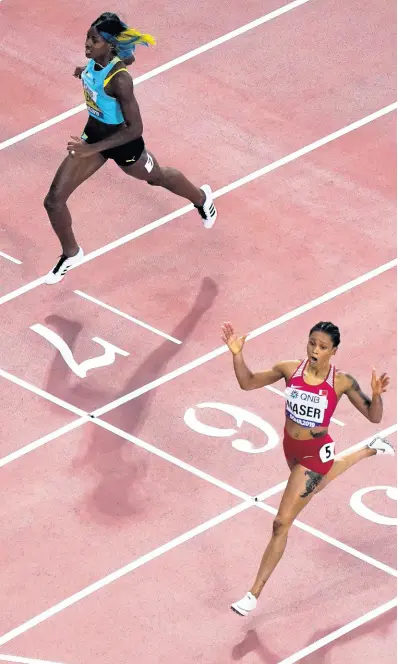  ?? AP ?? Salwa Eid Naser (right), of Bahrain, crosses the finish line in front of Shaunae Miller-Uibo, of The Bahamas, to win the women’s 400m final at the IAAF World Championsh­ips in Doha, Qatar, on Thursday.