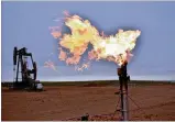  ?? MATTHEW BROWN/AP ?? A flare burns natural gas at an oil well in August in Watford City, North Dakota. Consumers of natural gas may face far higher heating bills this winter.