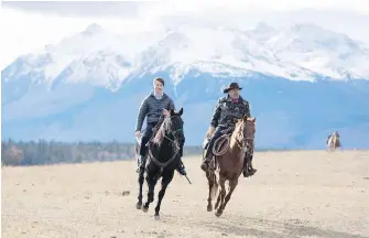  ??  ?? Prime Minister Justin Trudeau, left, and Tsilhqot’in tribal chairman Joe Alphone ride horses near Chilko Lake on Friday.