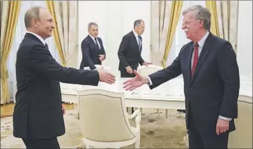  ?? Alexander Zemlianich­enko Pool Photo ?? NATIONAL security advisor John Bolton, right, and Russia’s Vladimir Putin, seen in June, are to meet again.