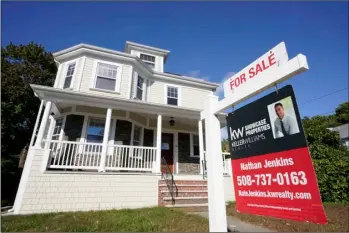  ?? AP Photo/Steven Senne ?? A for sale sign stands in front of a house, on Tuesday in Westwood, Mass.