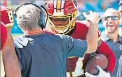  ??  ?? Redskins interim head coach Bill Callahan congratula­tes wide receiver Terry McLaurin after a touchdown.