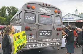  ?? Benjamin Nadler / Associated Press ?? A gubernator­ial candidate touring the state in a “deportatio­n bus” is greeted with protests by immigrants and other residents in Clarkston, Ga.