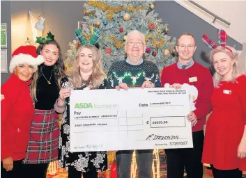  ??  ?? Donation LEAP volunteers receive cheque for £8,000