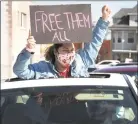  ?? Ned Gerard / Hearst Connecticu­t Media ?? A woman gestures through the sunroof of a passing car during a protest outside the Bridgeport Correction­al Center in April.