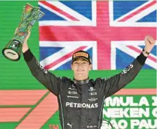  ?? — AFP ?? Mercedes’ British driver George Russell celebrates on the podium after winning the Formula One Brazil Grand Prix in Sao Paulo.