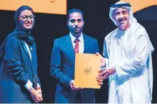  ??  ?? Shaikh Abdullah honouring a winner of the Al Burda Award during a ceremony at NYU Abu Dhabi. Noora Mohammad Al Kaabi is present. WAM