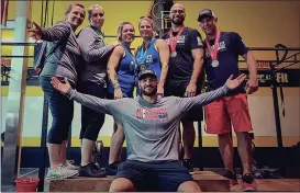  ?? CONTRIBUTE­D PHOTO ?? Members of CrossFit Oscar Mike pose for a photo with their medals won at the recent Festivus Games in Woodstock.