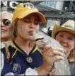  ?? MARK HUMPHREY — THE ASSOCIATED PRESS ?? Predators fan Anna Claire Massey kisses a catfish as fans celebrate before Game 4 Monday in Nashville.
