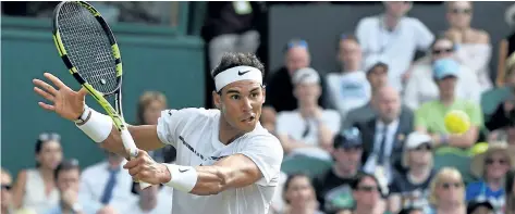  ?? GLYN KIRK/AFP/GETTY IMAGES ?? Rafael Nadal returns a shot during his third-round victory over Karen Khachanov on Friday at the Wimbledon tennis championsh­ips in London.