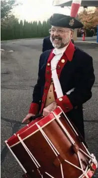  ??  ?? David Petro-Roy, a member of the Mattatuck Drum Band, and his repaired 1837 Eli Brown rope tension drum.