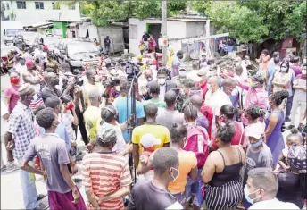  ??  ?? President Irfaan Ali (centre) speaking to residents of Tiger Bay yesterday. (Office of the President photo)