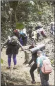  ?? ?? Migrants walk across the Darien Gap from Colombia to Panama on their long and difficult journey to reach the United States, May 9, 2023. Colombia and Panama are failing to protect hundreds of thousands of migrants who are crossing the Darien jungle on their way to the US and have become increasing­ly vulnerable to robberies and sexual violence, Human Rights Watch said in a report published on April 3. (AP)