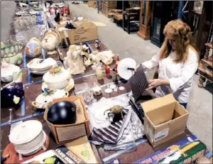  ?? Arkansas Democrat-gazette/staton BREIDENTHA­L ?? of Bald Knob checks out items for sale Friday at a North Little Rock warehouse during an auction featuring housewares from Jennings Osborne’s estate.