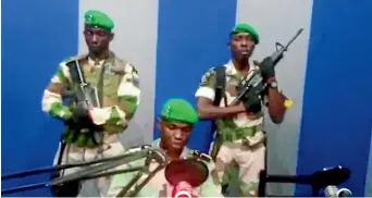  ?? AP ?? A soldier who identified himself as Lieutenant Obiang Ondo Kelly, commander of the Republican Guard, reads a statement on state television broadcast from Libreville, Gabon, saying the military has seized control of the government.