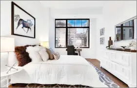  ??  ?? A hint of pastel pink serves as the perfect complement to chocolate brown in this bedroom. (Design Recipes)