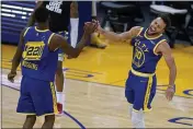  ?? TONY AVELAR — THE ASSOCIATED PRESS ?? The Warriors’ Andrew Wiggins (22) celebrates with Stephen Curry during the second half on Friday.