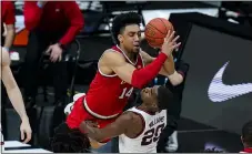  ?? MICHAEL CONROY — THE ASSOCIATED PRESS ?? Ohio State’s Justice Sueing draws a foul from Illinois’ Da’Monte Williams during the second half of the Big Ten Conference tournament championsh­ip game March 14in Indianapol­is.