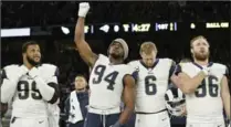  ?? MATT DUNHAM, THE ASSOCIATED PRESS ?? L.A. Rams’ Robert Quinn (94) raises his fist during the national anthem against the Arizona Cardinals before a 33-0 victory in London, England.