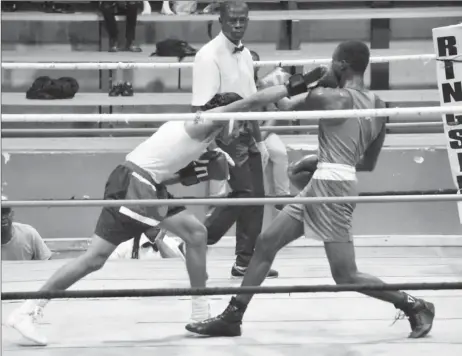  ??  ?? Kevin Allicock, the younger brother of standout boxer, Keevin Allicock (looking on), scored a unanimous decision victory against a game Kevin Isaacs of the GDF.