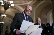  ?? ASSOCIATED PRESS FILE PHOTO ?? Senate Majority Leader Chuck Schumer, D-N.Y., joined at right by Majority Whip Dick Durbin, D-Ill., looks over his notes as he prepares to speak to reporters after a Democratic policy meeting at the Capitol in Washington.