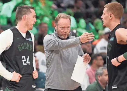  ?? MICHAEL SEARS/JOURNAL SENTINEL ?? (From left) Pat Connaughto­n, coach Mike Budenholze­r and Donte DiVincenzo aren't able to practice together as a team until next week, when the Bucks travel to Florida and settle into the NBA “bubble.”