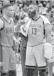  ?? Michael Wyke / Associated Press ?? With his left wrist wrapped, James Harden, right, takes time after Sunday’s Thunder game to talk with fellow MVP candidate Russell Westbrook.