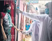  ?? ANI ?? ■ Health care workers wearing PPE kits examine residents living in the slum area at Malad in Mumbai on Wednesday.