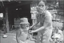  ?? PROVIDED TO CHINA DAILY ?? Center: A staff member at Mekong Plus gives hygiene tips to a boy in Vietnam last year.