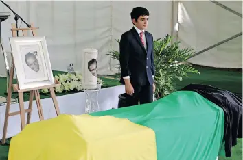  ?? ?? KADIN Ebrahim is pictured standing guard over his father at the special provincial official funeral service for Struggle hero Ebrahim Ismail Ebrahim yesterday. I TIMOTHY BERNARD African News Agency (ANA)