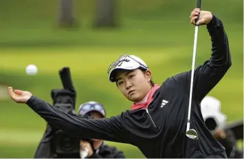  ?? SETH WENIG / AP ?? Rose Zhang loses her balance as she hits out of the rough on the first hole during the final round of the LPGA Cognizant Founders Cup on Sunday in Clifton, N.J.