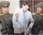  ?? AP ?? Otto Warmbier is escorted March 16, 2016, at the Supreme Court in Pyongyang, North Korea.