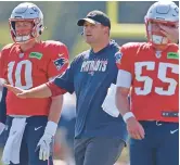  ?? BOSTON HERALD ?? Patriots assistant coach Joe Judge works with Mac Jones, left, and Bailey Zapp during training camp Aug. 2 at Gillette Stadium in Foxborough, Massachuse­tts.