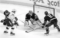  ?? FRANK GUNN/AP ?? Maple Leafs goaltender Jack Campbell makes a save as Tampa Bay’s Nikita Kucherov, front left and Toronto defenseman Jake Muzzin, right, look on during Game 5. The Lightning trailed the series 3-2 entering Thursday’s Game 6.