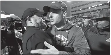  ?? AP/MICHAEL WOODS ?? Arkansas interim Coach Barry Lunney Jr. (right) talks with Missouri Coach Barry Odom after the Razorbacks’ season-ending loss to the Tigers on Friday in Little Rock. “Despite the circumstan­ces, it’s been a special time,” Lunney said. “I will always remember the way these guys have gotten behind me and listened to me and followed me.”