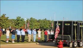  ?? KRISTI GARABRANDT — THE NEWS-HERALD ?? Veterans salute the Panels of the Moving Wall, a half scale replica of the Vietnam Memorial in Washington D.C when it arrived at Perry High School on Sept. 21.