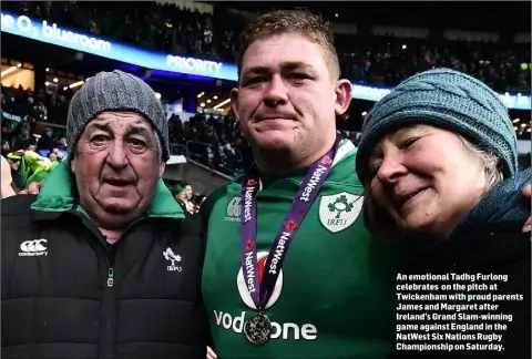  ??  ?? An emotional Tadhg Furlong celebrates on the pitch at Twickenham with proud parents James and Margaret after Ireland’s Grand Slam-winning game against England in the NatWest Six Nations Rugby Championsh­ip on Saturday.