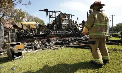  ?? Photograph: Rogelio V Solis/ AP ?? A fireman observes the remains of a burned Epiphany Lutheran Church near midtown Jackson, Mississipp­i.