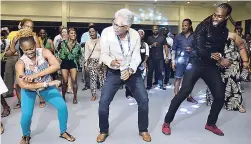  ??  ?? EC&C District Governor Robert ‘Bobby’ Moo Young (centre) showing he has moves at the Jamaica Night host party.