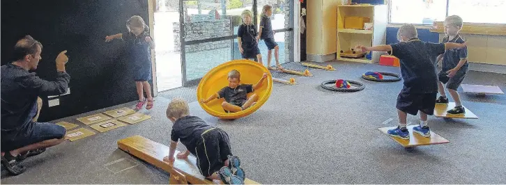  ?? PHOTOS: KERRIE WATERWORTH ?? Activities that use both sides of the brain . . . Wanaka primary AP Jason Cowan works with children from room 12 year 2 on their skipping, crawling and balancing skills in the perpetual motor programme room. From left to right are Jason Cowan, Hayley McMillan, Eddy Forster, Caleb Wilson, Izzy McFarlane, Livia Taylor, Campbell Brown and Archie Popperwell, all from Wanaka Primary.