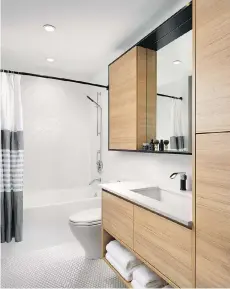  ??  ?? Bathrooms feature abundant storage and cabinets and shelves around the mirror provide a standout design element in the space.