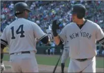  ??  ?? New York Yankees' Gary Sanchez, right, celebrates his solo home run with teammate Starlin Castro (14) during the eighth inning of a baseball game against the Texas Rangers in Arlington, Texas, Sunday.