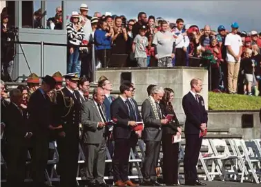  ?? AFP PIC ?? Britain’s Prince William (front right) and New Zealand Prime Minister Jacinda Ardern
(front second from right) attending the Anzac Day service at Auckland War Memorial Museum yesterday.