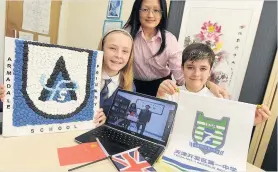  ??  ?? New links Pupils Natalie McGhie and Scott MacRae with Jean Ye, school link co-ordinator