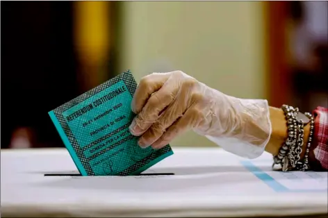  ?? CECILIA FABIANO/LAPRESSE VIA AP ?? A woman casts her ballot at a polling station, in Rome, Monday.