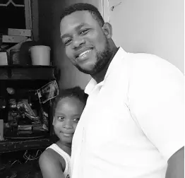  ??  ?? Shemar Miller is greeted by a young girl after giving care packages to her family in West Kingston.