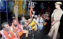  ?? — PTI ?? Security personnel keeping a vigil as sadhus gathered to head towards the Amarnath shrine cave, in Anantnag. Undeterred by the terror attack, the 13th batch comprising 3,791 pilgrims left for Amarnath on Wednesday