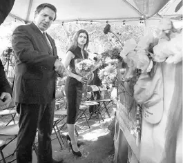  ?? STEPHEN M. DOWELL/ORLANDO SENTINEL ?? Gov. Ron DeSantis and his wife, Casey, carry flowers to the site of the Pulse nightclub in Orlando on June 12, 2019, the three-year anniversar­y of the Pulse nightclub shooting that killed 49, many Hispanic and LGBTQ. The Pulse nightclub site is now a memorial to the victims.